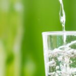 Macro shot of pouring water into a glass